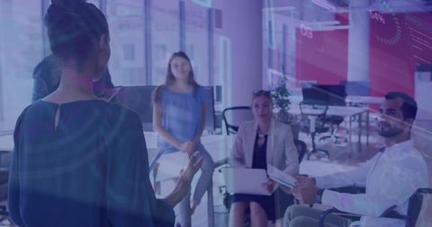 Business Woman Presenting to Team Amidst Digital Data Display