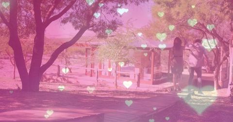 Couple walking along boardwalk to pavilion heart bokeh overlay romantic outdoor scene
