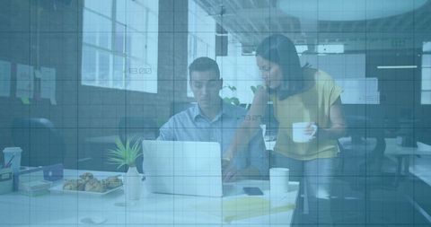 Coworker Assisting on Laptop in Modern Office Environment