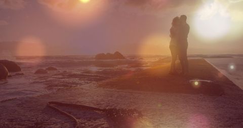 Romantic Couple Embracing at a Sunlit Beach Walkway - Download Free Stock Images Pikwizard.com
