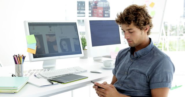 Creative Designer Using Smartphone in Modern Office - Download Free Stock Images Pikwizard.com