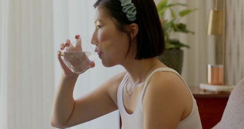 Woman enjoying refreshing glass of water
