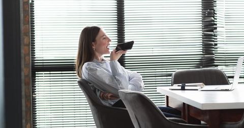 Thoughtful Professional Using Smartphone in Modern Office