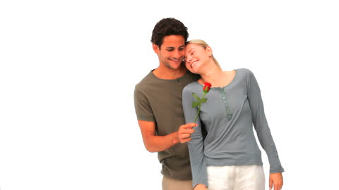 Romantic Couple Smiling with Rose on White Background