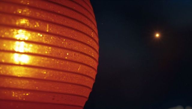 Glowing Red Paper Lantern with Star-like Light at Night