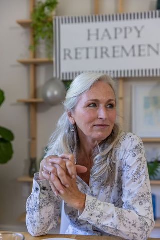 Elegant senior woman reflecting at retirement celebration