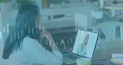 Woman engaged in virtual meeting with online security graphics