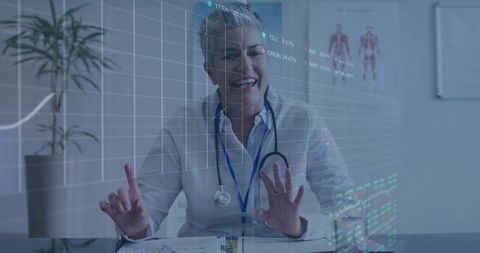 Senior female doctor gesturing at holographic medical data on clinic desk