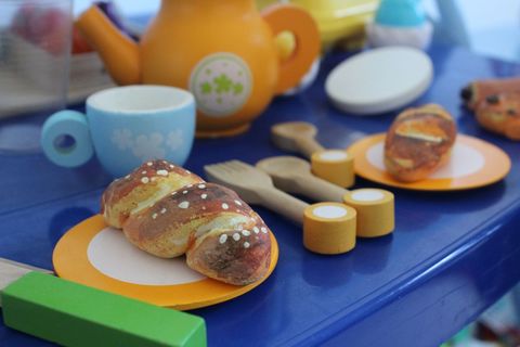 Kids play tea set with wooden toy pastries
