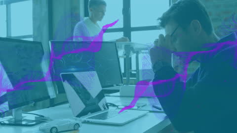 Stressed Caucasian Professional at Office Desk with Technology