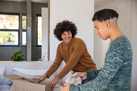 Diverse Friends Enjoying Unpacking in Cozy Living Room