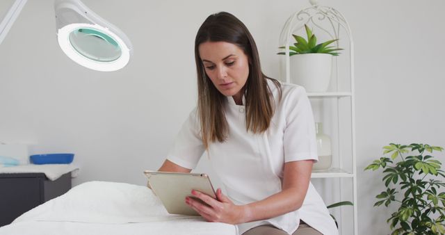 Skincare Professional Using Tablet in Modern Beauty Clinic - Download Free Stock Images Pikwizard.com