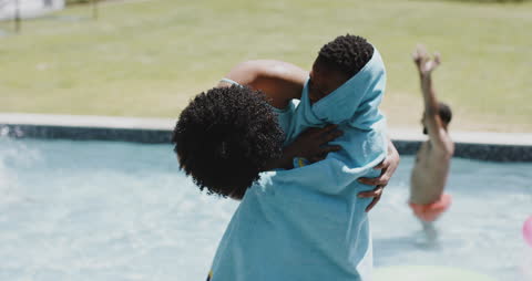 Mother Drying Son with Towel near Pool on Sunny Day
