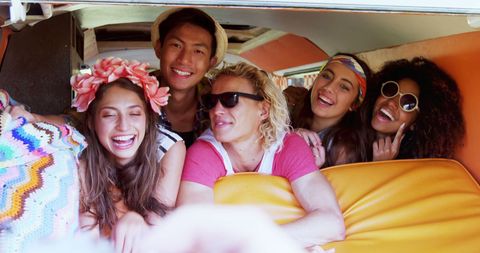 Joyful Friends on Road Trip Inside Vibrant Vintage Van
