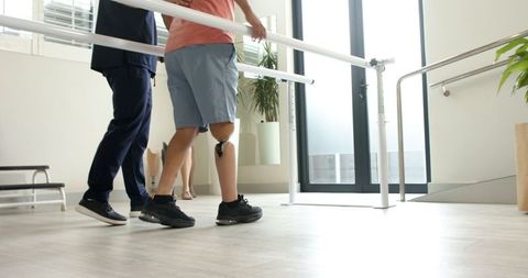Rehabilitation Therapy: Patient Practicing Walking with Prosthetic Limb