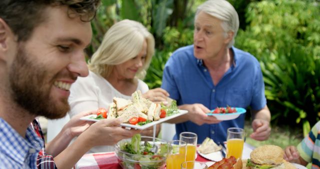 Family Enjoying Summer Picnic with Fresh Sandwiches and Salad - Download Free Stock Images Pikwizard.com