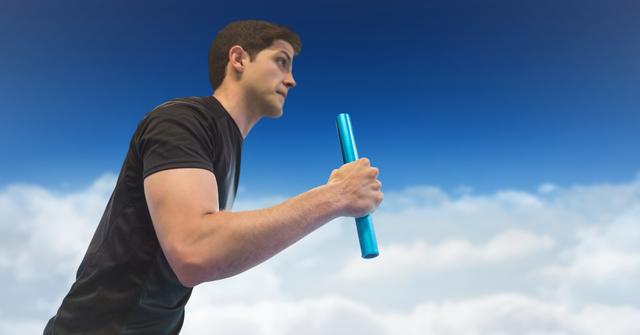 Athletic man running with baton in hand, wearing black outfit, background featuring cloudy blue sky. Can be used for sports promotions and inspirational material.