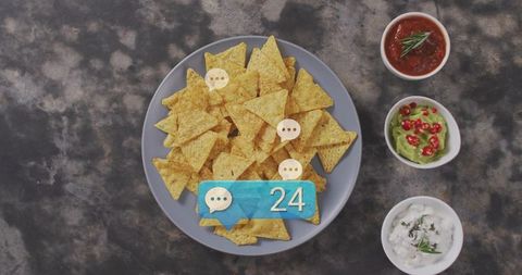 Overhead nacho platter with chips, salsa, guacamole, sour cream and notification badge