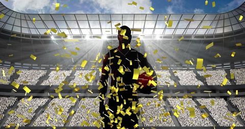 Triumphant basketball player with gold confetti in stadium