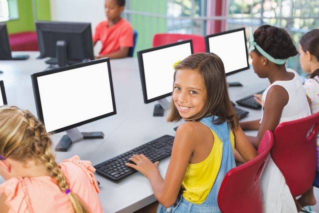 School kids using computer in classroom at school