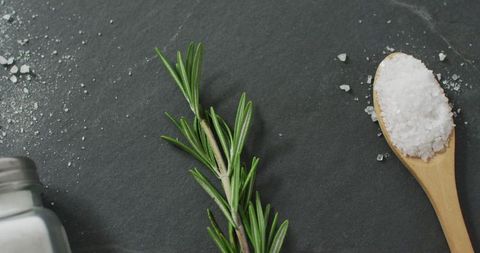 Rosemary and salt on stone surface for gourmet cooking