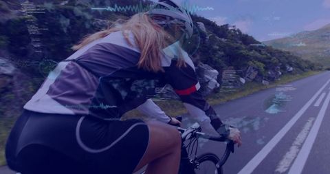 Female Cyclist Rides Through Scenic Mountain Route