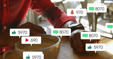 Man Checking Social Media Notifications on Smartwatch in Café