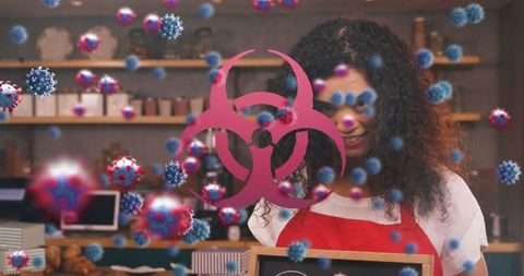 Smiling barista with biohazard symbols emphasizing health safety
