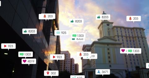 Digital Notifications Floating Over Cityscape at Sunset