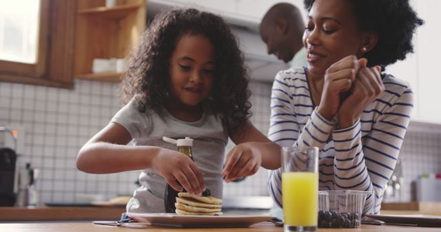 Family Breakfast with Mother and Daughter Making Pancakes - Download Free Stock Images Pikwizard.com