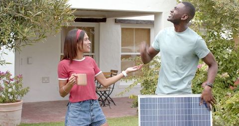 Diverse Couple Embracing Sustainable Living in Backyard
