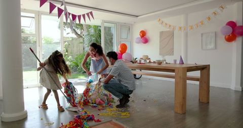 Family Celebrating Birthday at Home with Streamers and Balloons