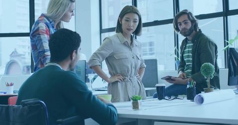 Team Collaborating at Open-Plan Office for Dynamic Project Discussion