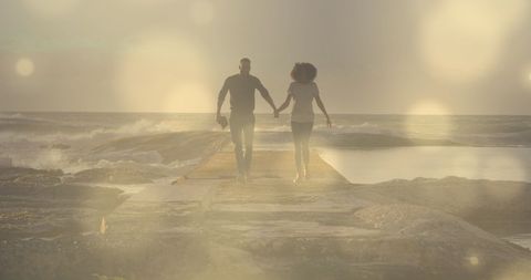 Romantic Couple Holding Hands by Ocean Sunset - Download Free Stock Images Pikwizard.com