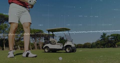 Golfer Preparing on Pristine Fairway near Golf Cart under Clear Sky