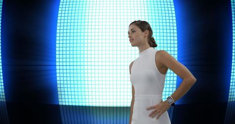 Confident woman in front of futuristic digital display
