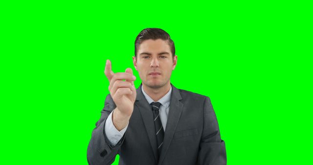 Businessman in a suit making a hand gesture, isolated on a green screen background. Useful for presentations, corporate videos, or business-related content where backgrounds can be edited to suit different themes.