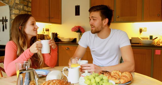 Young Couple Having Breakfast and Conversing at Home - Download Free Stock Images Pikwizard.com