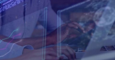 Hands Typing on Laptop with Graphical Data Interface Overlay