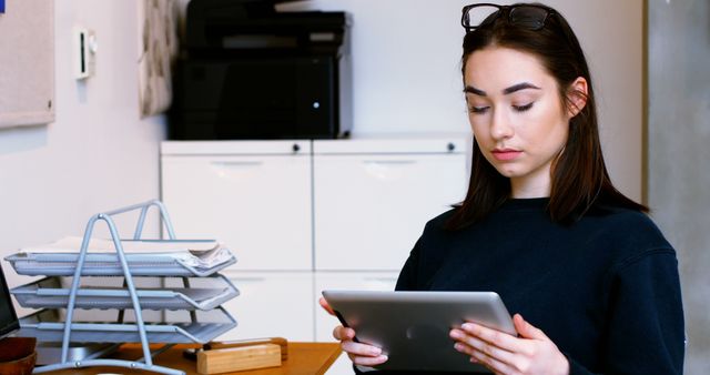 Focused Young Woman Using Digital Tablet in Home Office - Download Free Stock Images Pikwizard.com