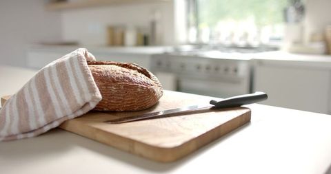 Sunlit Kitchen with Freshly Baked Bread on Cutting Board
