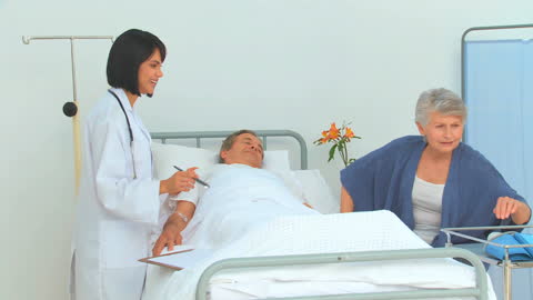 Nurse Checking on Elderly Patient in Hospital Setting