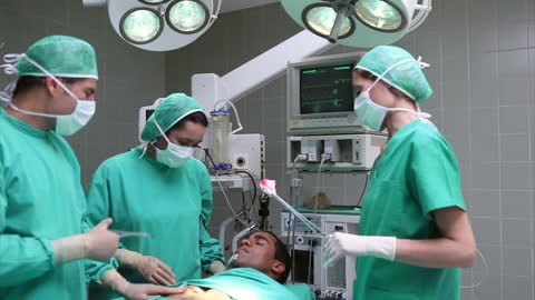 Surgeons Operating on Patient in Modern Surgical Theater