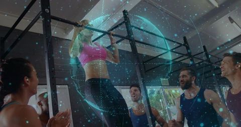 Woman Performing Pull-Up on Gym Rig with Holographic Globe Overlay and Group Cheering
