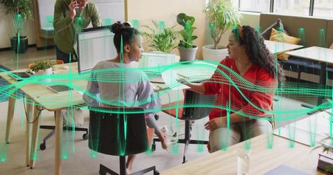 Women collaborating and sharing documents with holographic data waves for teamwork in office