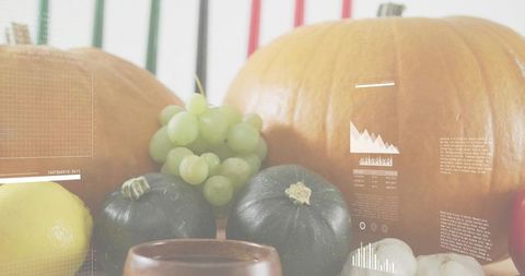 Centering autumn harvest display featuring pumpkins, grapes, squashes, lemon and gourds