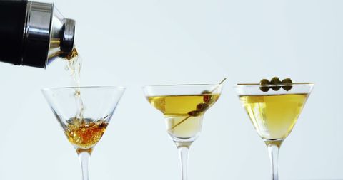 Pouring Cocktails into Martini Glasses with Variety and Elegance - Download Free Stock Images Pikwizard.com