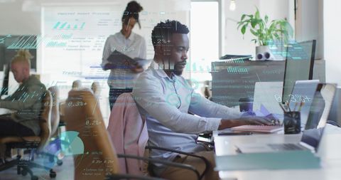Business Team Analyzing Data on Computers in Modern Office