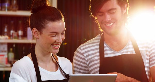 Smiling Café Staff Working Together with Tablet - Download Free Stock Images Pikwizard.com