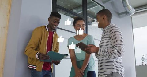 Diverse Team Collaborating in Modern Workspace with Thumbs-Up Icons